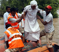 NDRF men rescuing an elderly marooned in flood at the Sadhuwala village in Mansa district