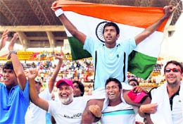 Rohan Bopanna, Somdev Devvarman and Leander Paes celebrate their victory after beating Brazil 3-2 during the Davis Cup world group playoff in Chennai on Sunday