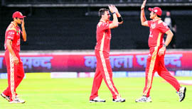 Royal Challengers Bangalores Dale Steyn (C) is congratulated by teammate for the dismissal of Mumbai Indians batsman Shikhar Dhawan (not pictured) during the Champions League Twenty20 League match in Durban, on Sunday