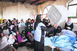 An election worker displays an empty ballot box to polling agents during counting at a polling station in Kabul on Sunday.