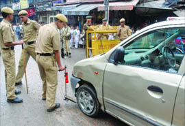 Police personnel check a car near the Jama Masjid in New Delhi on Monday. 