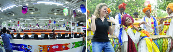 A view of the Games media centre in New Delhi on Monday. (Right) A foreigner dances with folk artistes during the inauguration of a tourists info caf at Birla Mandir.