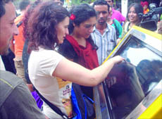 A tourist uses the touchscreen at the tourists info cafe at the Red Fort in New Delhi on Monday.
