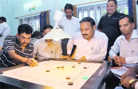 A match in the Bar Association Carrom Tournament being played in Dehradun on Monday.