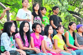 Students from the North-east watch a football match at the Pavilion Ground in Dehradun on Monday.