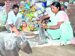 Shanta Devi fills packets of vermicompost at the Kachre se Kamai shed in village Sanwla of Kurukshetra on Monday.