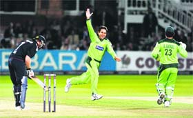 Pakistan's Saeed Ajmal (centre) celebrates taking the wicket of England's Ian Bell (L) during the 4th Natwest ODI in London