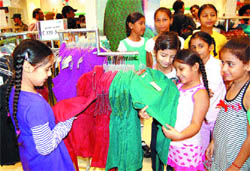 Children look at garments in the newly opened Max store in Amritsar.