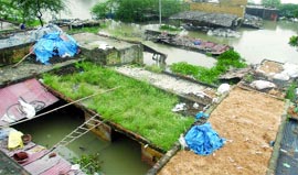 Deluged and Displaced A view of the flooded Usmanpur village in New Delhi on Tuesday.