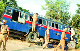 Delhi-bound Punjab Police personnel take out their stuff from their bus after the accident near Chaherru on Tuesday