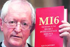 Historian Keith Jeffery poses for photos with a copy of his book The History of the Secret Intelligence Service in London on Tuesday.
