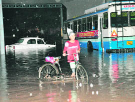 A car and a bus stuck in the industrial area following heavy rain in Chandigarh on Wednesday.