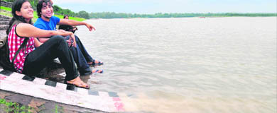 Youngsters relax after rain at Sukhna Lake in Chandigarh.