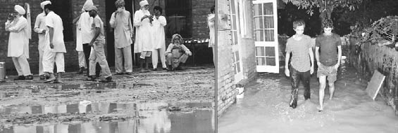 Protesting BKU farmers find no place to sit as rain lashed the town; and rainwater enters government houses at Phase VI in Mohali on Wednesday.