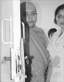 Victims show the broken door of their house in Army flats, Sector 20, Panchkula, on Wednesday.