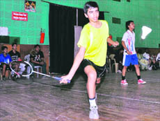 A player in action at a match of the Boys District-Level Badminton Tournament in Dehradun on Wednesday. 
