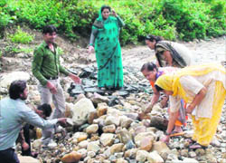Former Mayor Manorama Dobriyal Sharma participates in a shramdan to repair the Santhala Devi road in Dehradun on Wednesday.