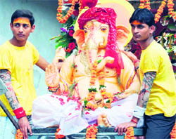 Devotees take an idol of Lord Ganesha for immersion in the Ganga in Haridwar on Wednesday