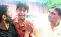 A grieving Vijenders son with a relative at his Gurgaon residence