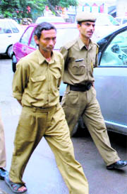 Accused postman Jagdish Chand outside a court in Dharamsala on Wednesday.