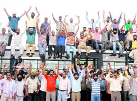 Members of the All-J&K SRTC Consolidated Drivers Welfare Association protest in support of their demands in Jammu on Wednesday