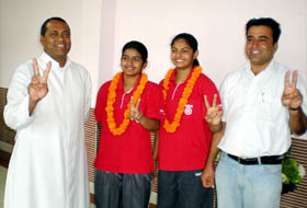 Ajashanjot Kaur and Anmol Kaur, students of St. Xaviers Senior Secondary School, flash victory signs in Bathinda.