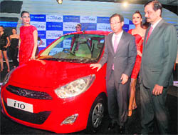 Hyundai Motors managing director and CEO HW Park and director sales Arvind Sexana along with models pose with the Next Gen i10 at its launch in New Delhi on Thursday.