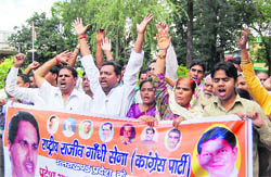 Workers of the Rashtriya Rajeev Gandhi Sena protest outside the District Magistrates office in Dehradun on Thursday.