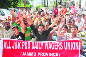 Members of the J&K PDD Daily Wagers Union protest in support of their demands in Jammu on Thursday. 