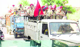 The police holds flag march in Mandi Ahmedgarh on Thursday.