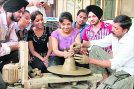Students of INIFD learn pottery during a creative workshop in Ludhiana.