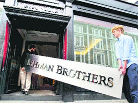 The Lehman Brothers corporate sign in polished metal is taken into an auction house in London on Friday. The sign, estimated to sell for 2,000-3,000 pounds, will go on sale in the Christie's auction of Lehman Brothers Artwork and Ephemera on September. 29. 