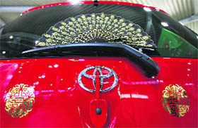 Toyota Motor Corp's iQ vehicle, which the company says is decorated with Chinese ornaments for good luck, is pictured at the company showroom in Tokyo on Friday.