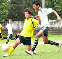 Players vie for the ball during a match of the Stephen Hishey Memorial Football Tournament in Dehradun on Friday.