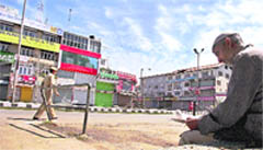 A man reads a local daily in the Lal Chowk area in Srinagar