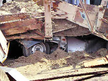 The car that crushed under a truck laden with sand in Doraha on Friday