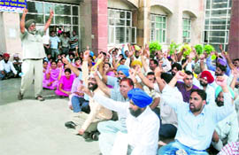 Members of the Punjab State Ministerial Services Union raise slogans against the state government at a protest rally held at the Mini-Secretariat in Bathinda on Friday