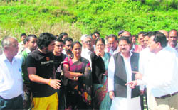 Education Minister Gobind Singh Bisht (in black vest) meets flood victims in Nainital
