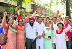 Congress workers hold a protest in Dehradun on Saturday