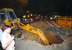 A stretch caved in near Hailey Road on Kasturba Gandhi Marg in New Delhi on Sunday.