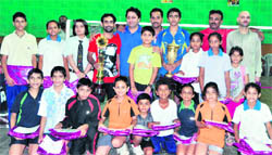 Winners of the District Badminton Championship in Dehradun on Sunday.