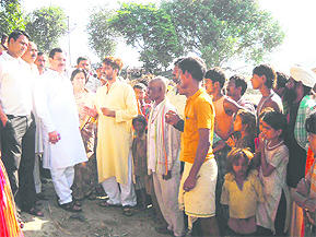 Leader of the Opposition Harak Singh Rawat listens to flood-affected people in Haridwar on Sunday.