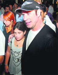 Hollywood actor John Travolta (R) and his daughter Ella Blue leave the Chattrapati Shivaji International Airport in Mumbai on Sunday. The 56-year-old flew into Mumbai on his own jet for two days to launch a new model of Breitlings aviation watches, which he has endorsed for the past five years. 