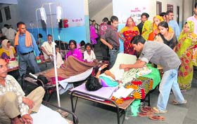 Patients suspected to be suffering from dengue lie on their own beds in the corridor of the packed Civil Hospital in Jalandhar