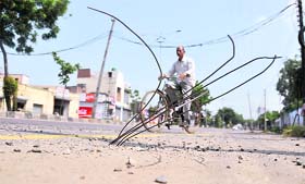 Iron rolls jutting out of a road in Ludhiana, posing a threat to the commuters