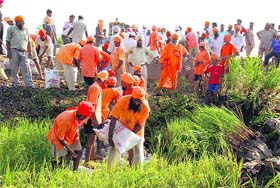 Villagers take part in relief work at a site eroded by the Sutlej, in Jalandhar