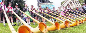 Alphorn blowers of the Oktoberfest orchestra play at the Oktoberfest beer festival in Munich on Sunday. The musicians of the beer tents meet annually for the traditional Oktoberfest concert.