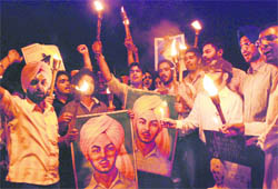 Members of a students organisation hold a candlelight march on the eve of Shaheed Bhagat Singhs birth anniversary at Panjab University in Chandigarh