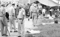 Policemen conduct a search at a slum in Zirakpur 