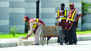 Labourers work at the Games Village ahead of the mega event in New Delhi on Monday.